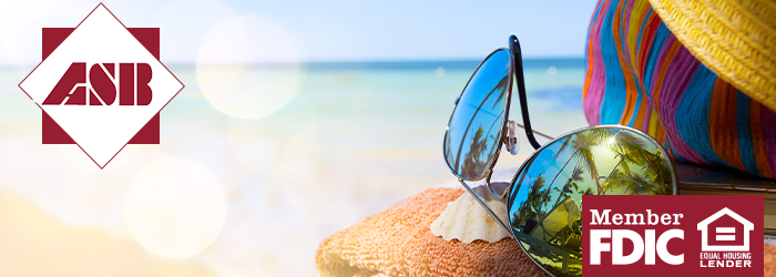 Close up shoot of sunglasses with reflection of palm trees on a towel with ocean in the background 