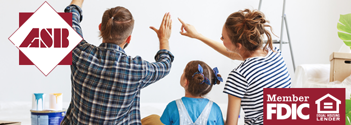 Father, mother, and daughter sitting on the floor envisioning paint on their new home's walls with paint cans on the floor by them