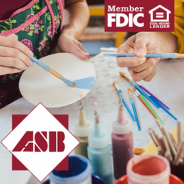 Two people painting a plate and vase