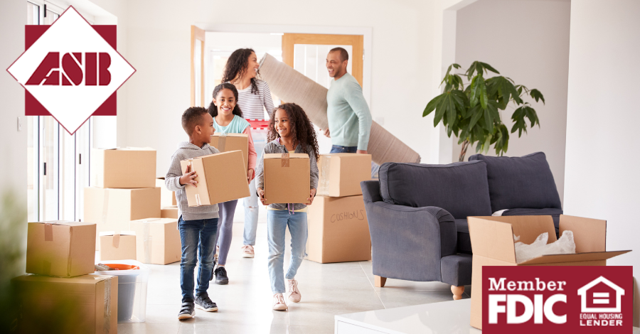 Family of five holding moving boxes in new home